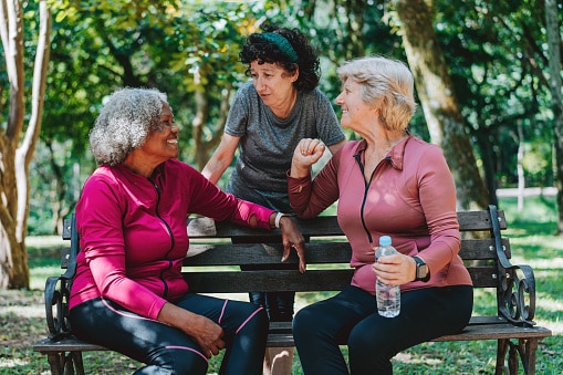 Small group of friends talking in the park.